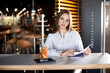 © Анжелика Мельничук - girl sits at a table in a cafe and holds documents in her hands