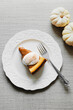 © Ellie Baygulov/Stocksy - A slice of a pumpkin cheesecake