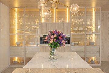 luxury interior design of modern trendy snow white kitchen in minimalistic style with island and two bar stools. huge windows to the floor and a glass rack for dishes