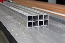 The Pipe Sections. Aluminium Profile For Manufacturing. Structural Metal Aluminium Shapes. Aluminium Profiles Texture For Constructions.