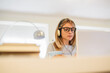 © MyMicrostock/Stocksy - Woman using a Laptop with Headphones at Home