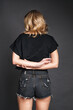 © Danil Nevsky/Stocksy - Faceless woman with hands behind back