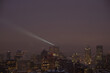 © Erik Naumann/Stocksy - Building searchlight at night