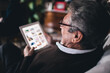 © Leandro Crespi Studio/Stocksy - Granparent using tablet - accesibility - Everyday technology