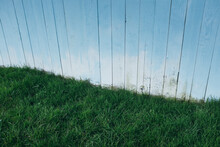 Painted Blue Wood Fence, Grass In Foreground