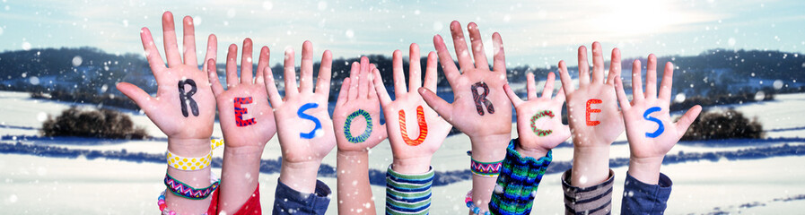 Wall Mural - Children Hands Building Colorful Word Resources. Snowy Winter Background With Snowflakes