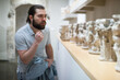 © JackF - Man visiting sculpture hall in historical museum and looking at exhibits. High quality photo