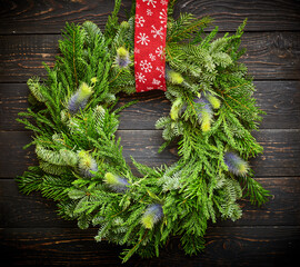 Wall Mural - Christmas wreath on dark wooden background