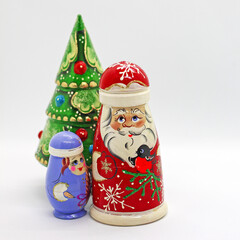 Wall Mural -  Russian wooden dolls - matrioshka. Father Frost, Snow-maiden and new year tree. Popular souvenirs from Russia