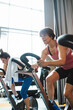 © Rob and Julia Campbell/Stocksy - Happy middlle aged woman enjoying working hard during spin cycle class