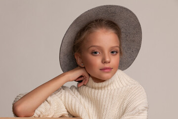 Portrait of a beautiful blonde girl in a hat