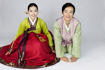 young woman and man in korean traditional clothing, hanbok