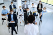 © Drazen - Large group of business people and healthcare workers with face masks on educational seminar.