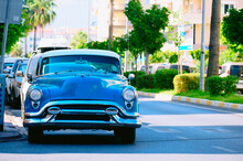 Blue Retro Car Is Parked By The Road In The Southern City.