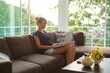 © Brkati Krokodil/Stocksy - Woman Sitting in the Living Room And Working On The Laptop
