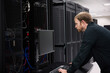 © Curtis Kim/Stocksy - Young IT professional working on datacenter servers
