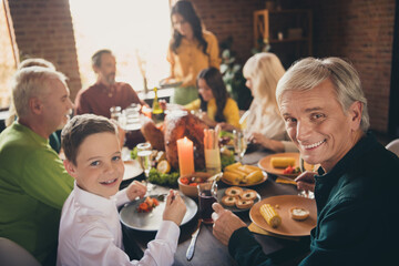 Portrait of nice attractive lovely cheerful family enjoying eating homemade tasty yummy dishes grilled turkey November harvest festive at modern loft industrial brick interior house indoors