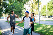 © Zoran Zeremski - Group of young people in sports clothing running in city park.
