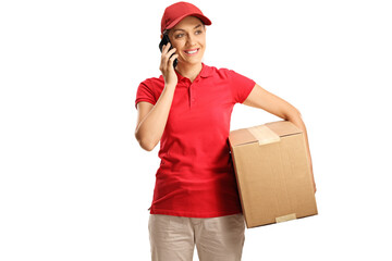 Female courier holding a cardboard box and talking on a mobile phone