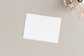 Wall Mural - White invitation card mockup with gypsophila. 5x7 ratio, similar to A6, A5.