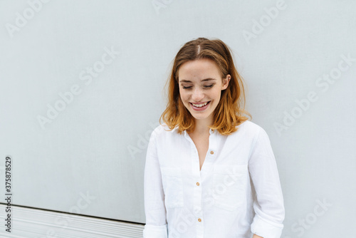 Cuadros en Lienzo Young woman standing with downcast eyes
