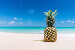 Pineapple on tropical beach background. Summer vacation and healthy food concept.