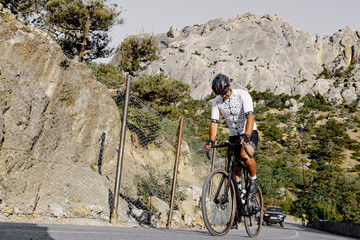 Wall Mural - Professional road bicycle racer in action on mountain road