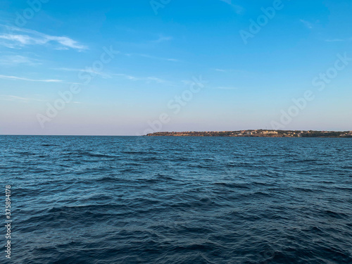 Fotomural Seascape with wide and calm waters at sunset