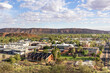 Views of Alice Springs township from Anzac hill. Mountains MacDonnell ranges close to the city. Houses, school and warehouses. Alice Springs, Stuart highway, Red centre of Australia