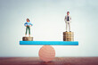 © tomertu - Conceptual image of gender inequality. A woman and a man on either side of the scales, with income difference