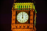Fototapeta Big Ben - Big Ben of the Houses of Parliament London England UK at night striking midnight on New Years Eve which is a popular travel destination tourist attraction landmark of the city centre stock photo image