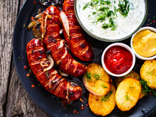 Grilled Sausages On Wooden Board

