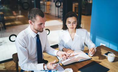 Sticker - Focused coworkers analyzing business data in office