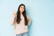 © Asier - Young indian woman isolated on blue background showing number two with fingers.