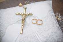 Gold Rings And Cross On The Wedding Cushion