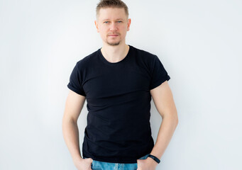 Handsome man posing in black blank t-shirt