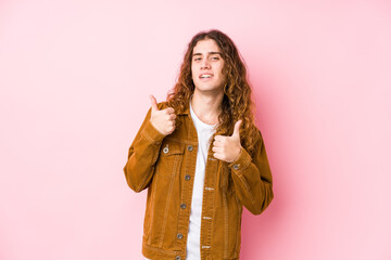 Wall Mural - Young long hair man posing isolated raising both thumbs up, smiling and confident.