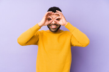 Wall Mural - Young mixed race arabic man isolated showing okay sign over eyes