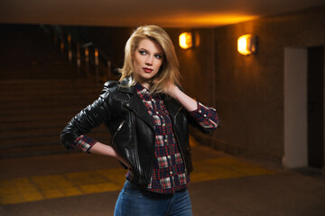 Wall Mural - Young fashion blonde woman in black leather jacket