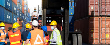 Strike Of Workers In Container Yard. Group Of Multiethnic Engineer People During A Protest In Workplace
