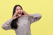 © PK Studio - Asian women announce on a yellow background.