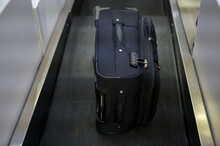 Luggage On Weight On The Conveyor Belt At Check-in Counter At Airport