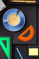 Sticker - office supplies and cup of coffee at black background