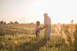 © Maria - Happy senior man Grandfather with cute little boy grandson playing in field. Happy child with Grandfather playing outdoors