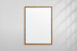 © Omeris - Mockup wood frame photo on wall. Mock up wooden picture framed. Vertical boarder with shadow. Empty photoframe a4 isolated on background. Border for design prints poster and painting image. Vector