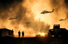 Military Helicopters, Forces And Tanks Between Smoke In Battle Field At Sunset