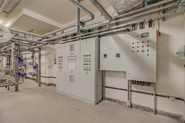 control cabinet in control room. Mechanic's maintenance room concept. Green, yellow, red button on white cabinet. Electrical cabinet in room. Distribution board. panelboard, breaker panel