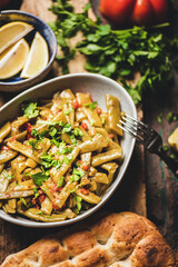 Wall Mural - Turkish traditional braised green beans starter with tomato and olive oil over wooden rustic table, top view, seelctive focus. Turkish regional cuisine, vegan, vegetarian food