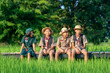 © visoot - America boy scouts in uniform sitting in green field on a sunny day while,Summer camp.