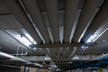Leinwandbilder - Underground piping service system in an office building car parking delivering fresh water, sewage, electrical and gas to the offices and shop floors above